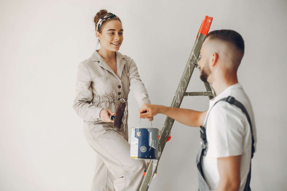 couple peignant les murs de la chambre